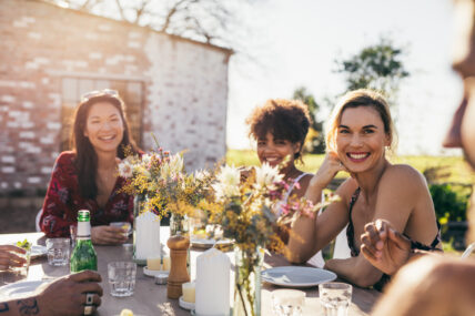 Young people partying in a restaurant outdoors.
