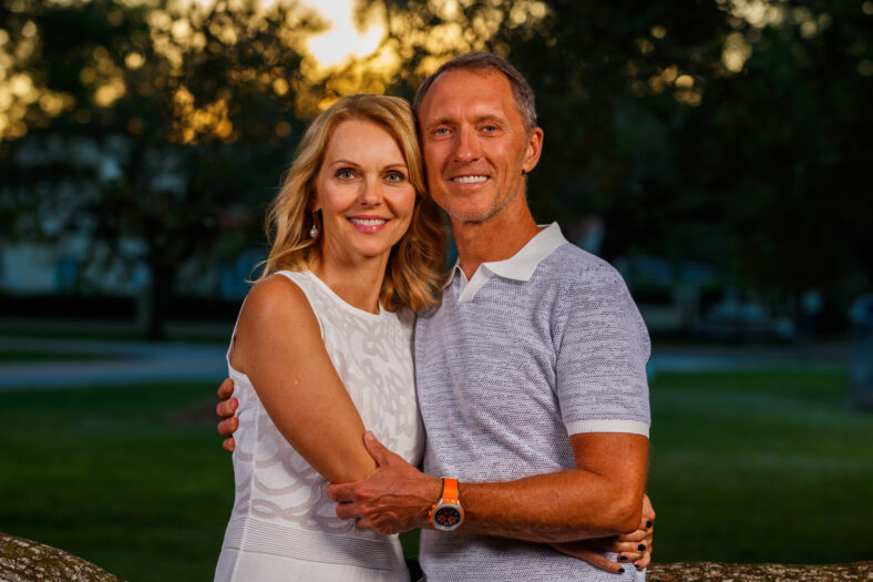 Attractive middle age couple outdoor lifestyle portrait in a park setting.