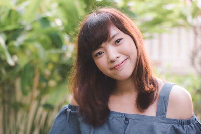 Close up of young pretty Asian woman in the garden.