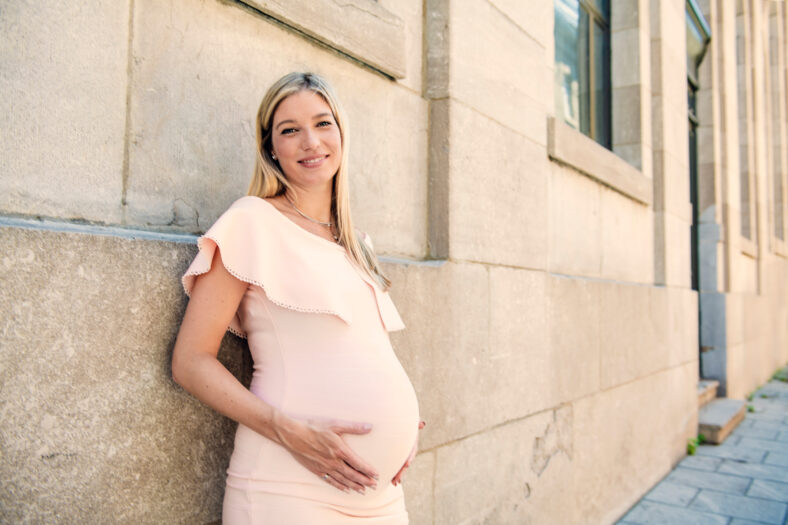 A Portrait of a pregnant woman in city street