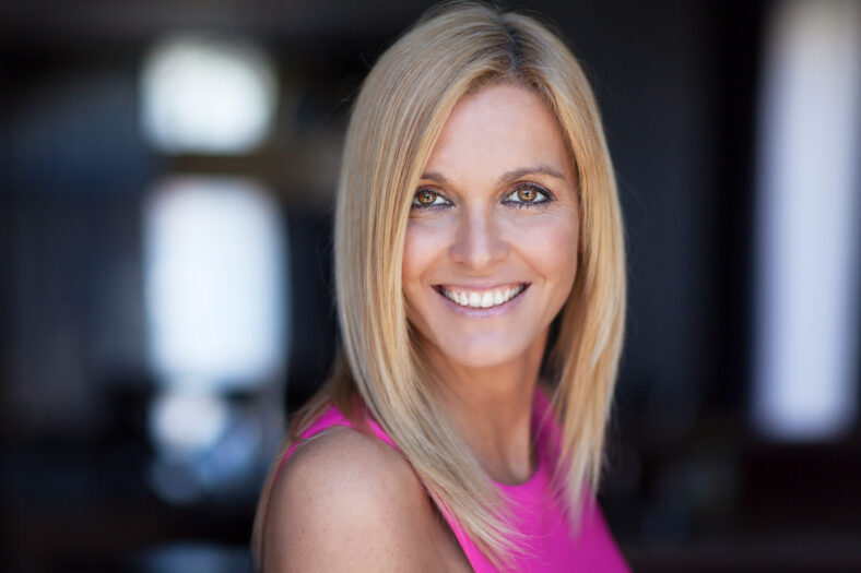 Portrait Of A Mature Woman Smiling At The Camera On a window background