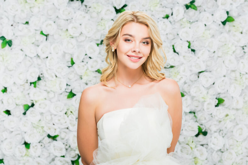 beautiful young woman with blonde hair on white floral background