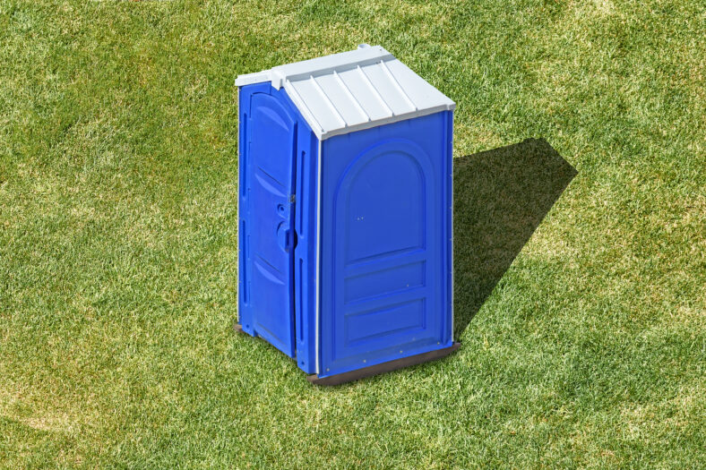 public portable plastic restroom cabin on green grass lawn aerial view of clean outdoor mobile toilet against nature background isolated bathroom lavatory exterior