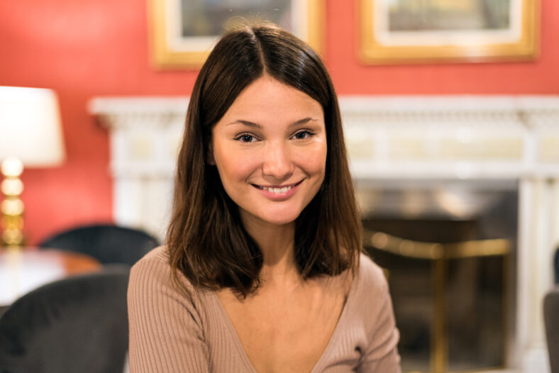 portrait of a young attractive woman looking at camera in a elegant hotel cafeteria