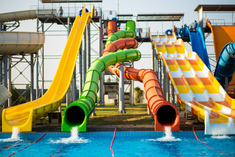 Colorful slides in outdoor water park in summer resort