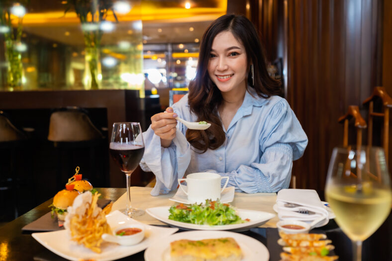 young beautiful woman eating in the restaurant