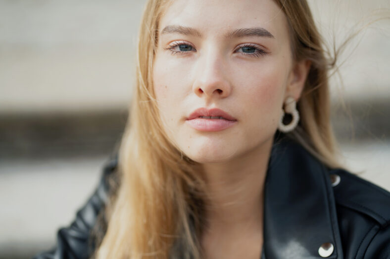 close up portrait of a young woman lady of Caucasian appearance, beautiful calm confident posing looking at the camera