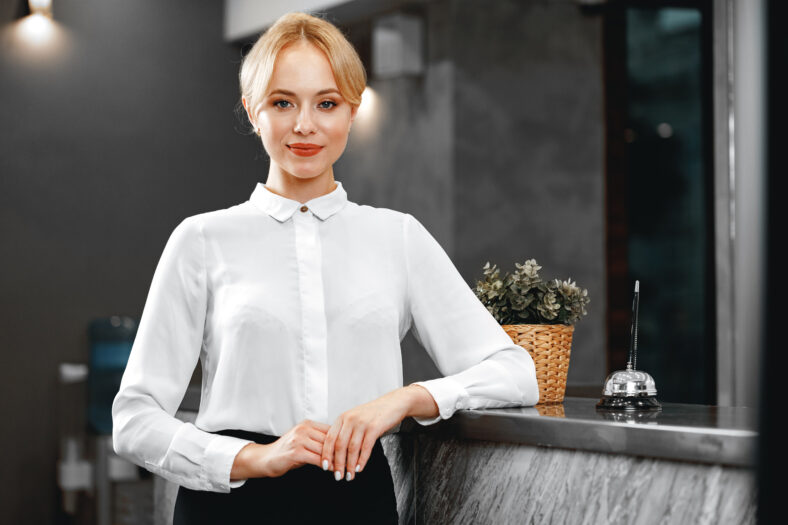Portrait of beautiful blonde woman hotel receptionist close up