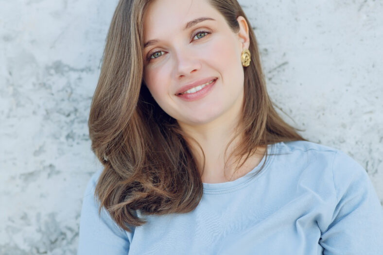 Beautiful smiling woman. Portrait of a young woman with regular features. High quality photo.