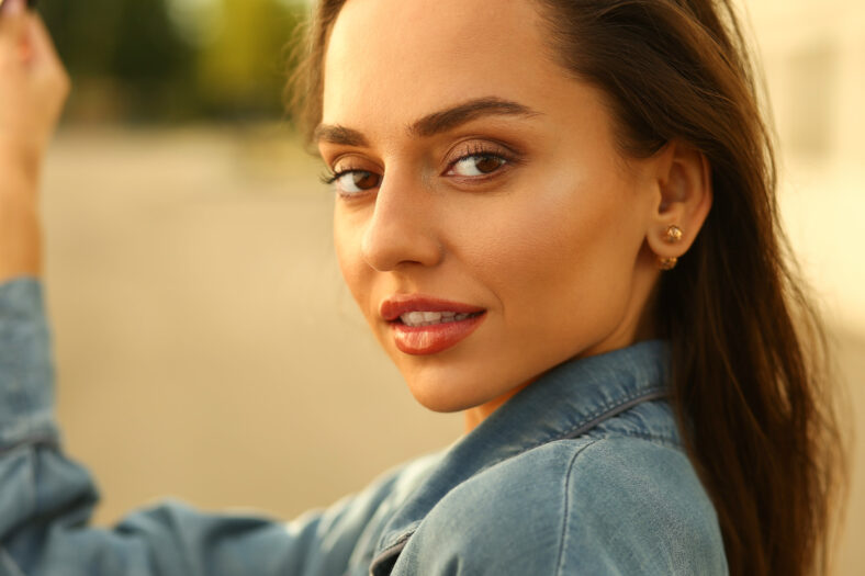 a gorgeous cute brunette smiles at the camera. portrait photos