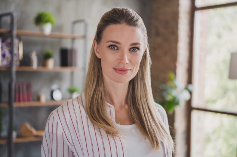 Photo of nice young blond lady wear white shirt at home alone.