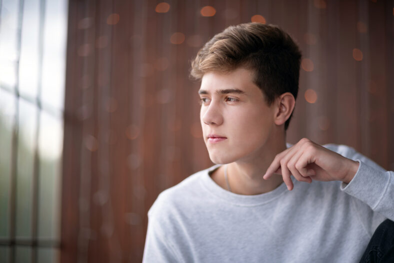 Handsome teenager guy 16-18 years old. Close up portrait of caucasian young man