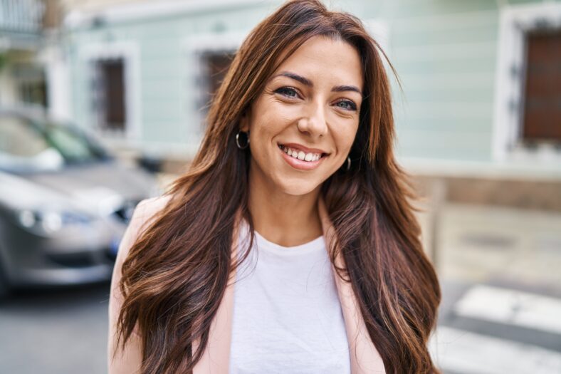 Young hispanic woman smiling confident walking at street