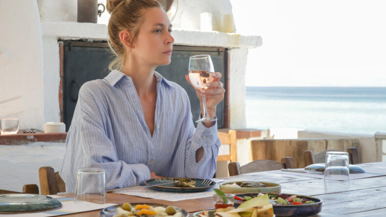 Young woman eating alone in the restaurant. Concept of solo dining in a casual restaurant. Eating out alone.