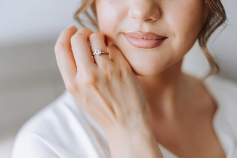 tender hands of a young woman with an expensive ring and a beautiful manicure. Close-up photo of female hands
