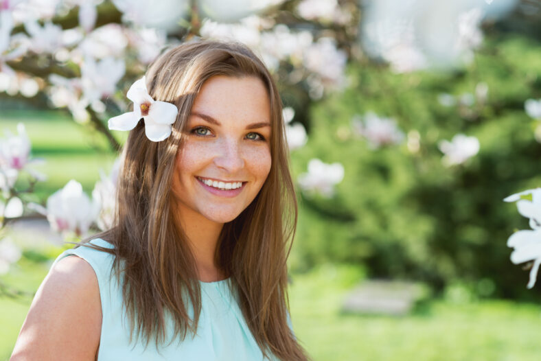 beautiful woman in blossom park smiling