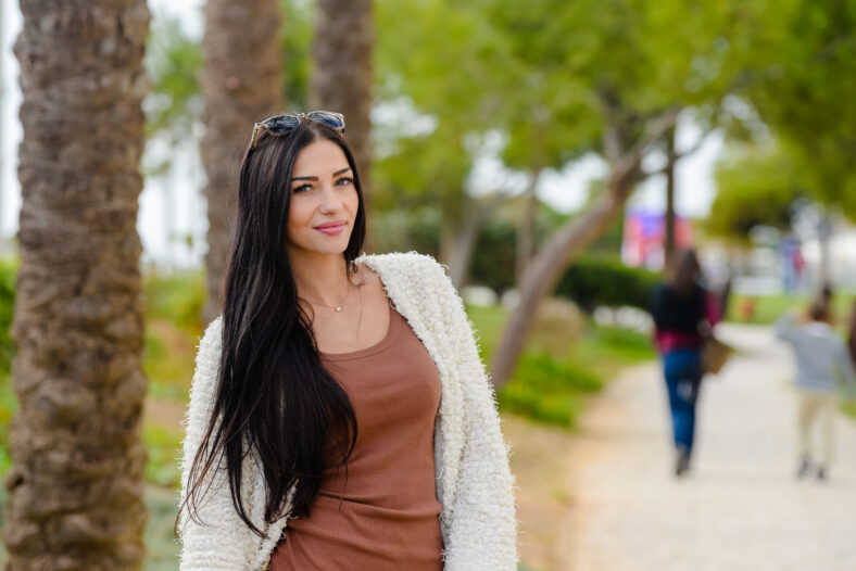 Portrait of beautiful smiling active woman walking outdoors background