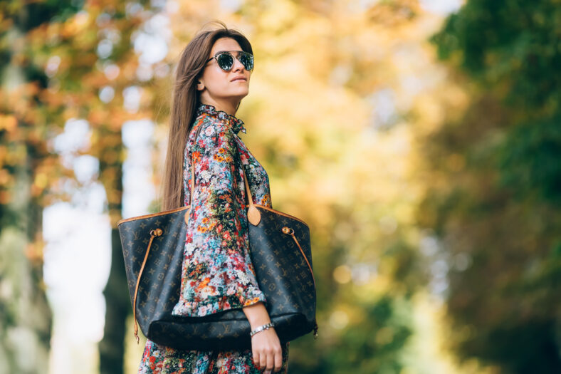 Young pretty woman at the autumn park. sunset