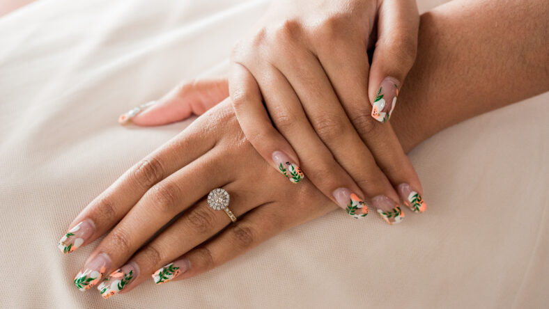 Close up of hands and large round halo wedding engagement diamond ring