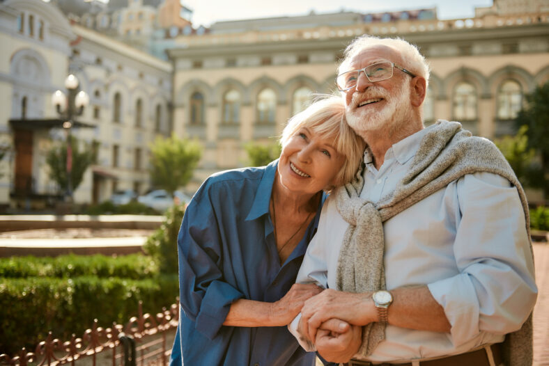 We love to travel together. Happy senior couple bonding to each other and smiling while standing outdoors. Family. Love concept