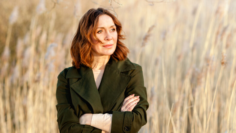 portrait of lovely middle aged woman posing at sunset.