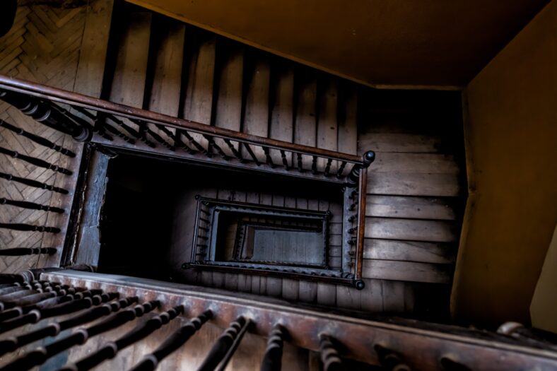 High angle aerial above view down of old vintage staircase winding spiral in Lviv, Ukraine, Europe with nobody architecture dark low-key abstract pattern