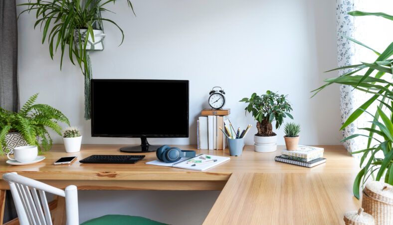 Blank screen of monitor in computer on wooden office desk in sty