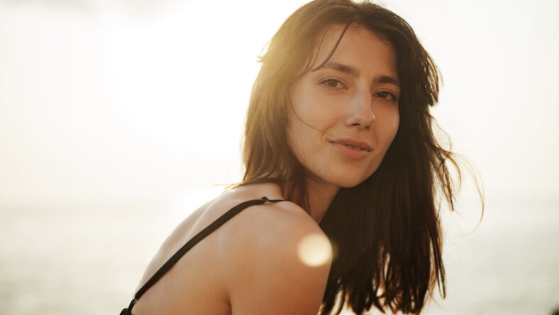 Young smiling woman outdoors portrait at the beach