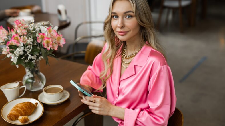 portrait of beautiful young woman with make-up with mobile phone