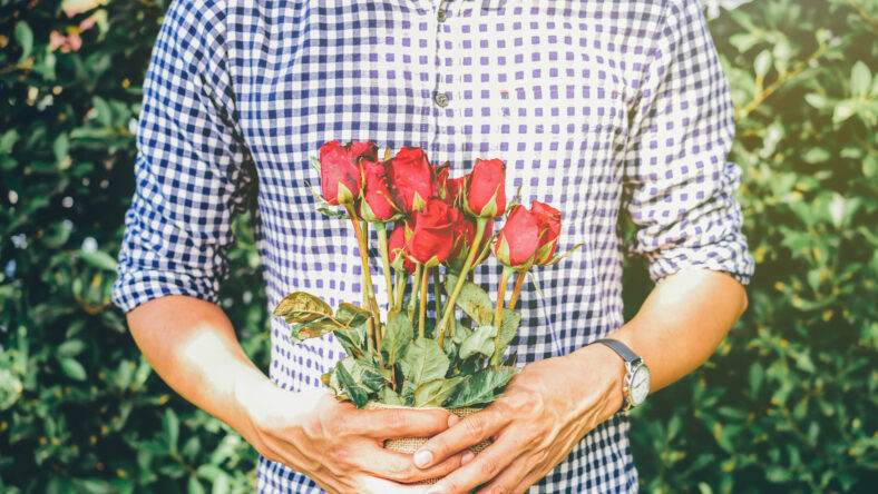 A man holding red roses in the garden.Soft Focus Image.