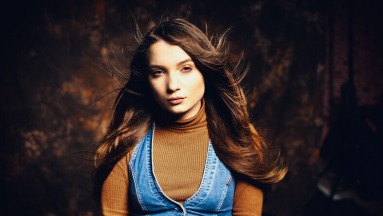 Emotion on the face of a beautiful girl on a canvas backdrops background