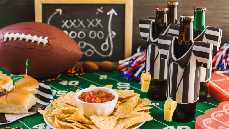 Game day football party table with beer, chips and salsa.