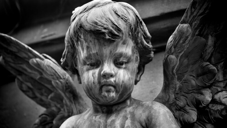 Statue of a baby angel on the graveyard