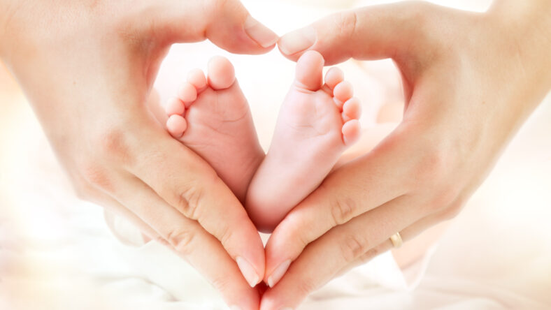 mom holding baby feet