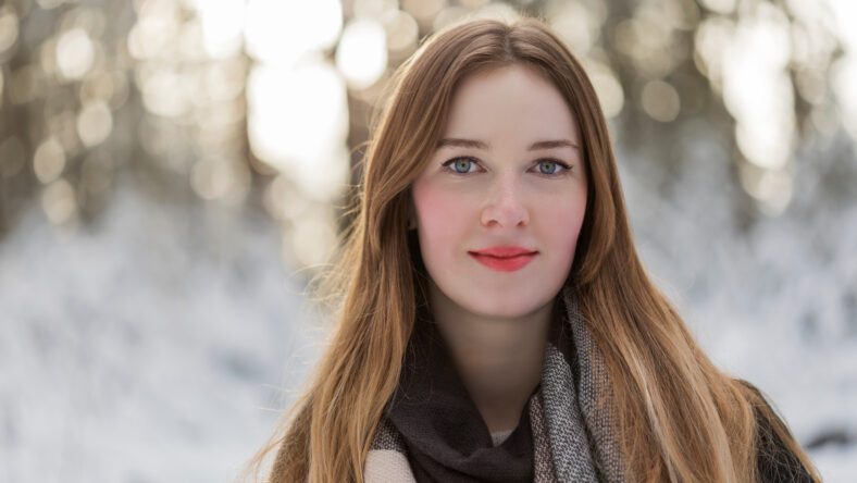 young woman snow walk beauty portrait fun smile candid