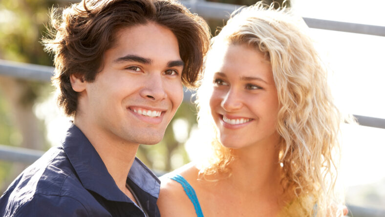 teen boy and girl sitting on the playground