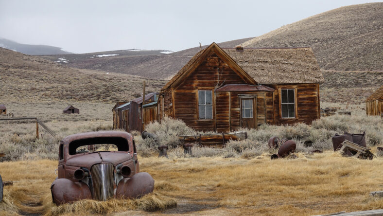 Rusty car slowly decaying in the rugged wilderness in the heart of California.