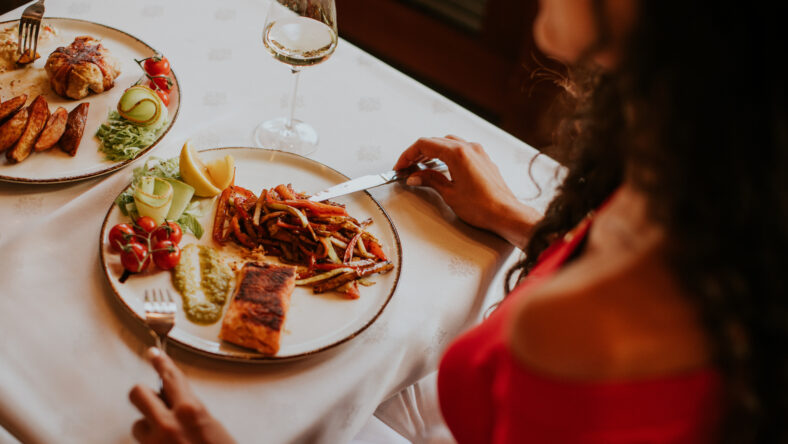 Handsome young couple having lunch with white wine in the restaurant