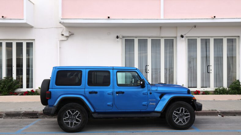 Jeep Wrangler Sahara 4x4 car parked in Italian town. There are 40 million cars registered in Italy (2023).