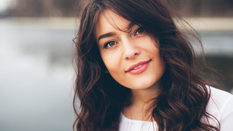 Beautiful smiling plump girl. Closeup portrait of gorgeous woman looking to camera