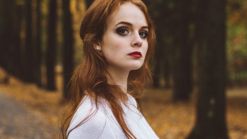 Portrait of happy beautiful redhaired girl smiling.