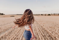 Summer Girl enjoying nature on yellow field.