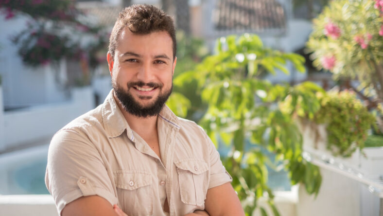 Gardener posing looking at camera in sunny summer day smiling