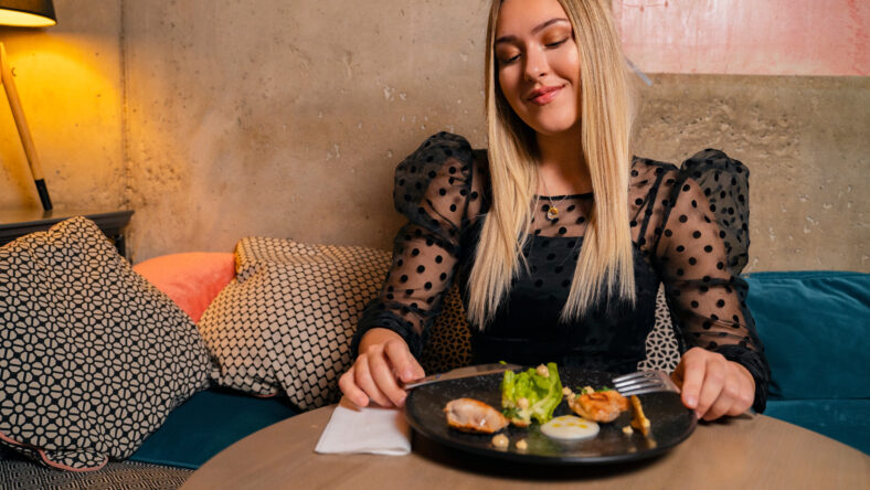 Beautiful young woman dinning in launge restaurant