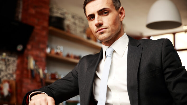 Confident businessman in formal cloths resting in the kitchen