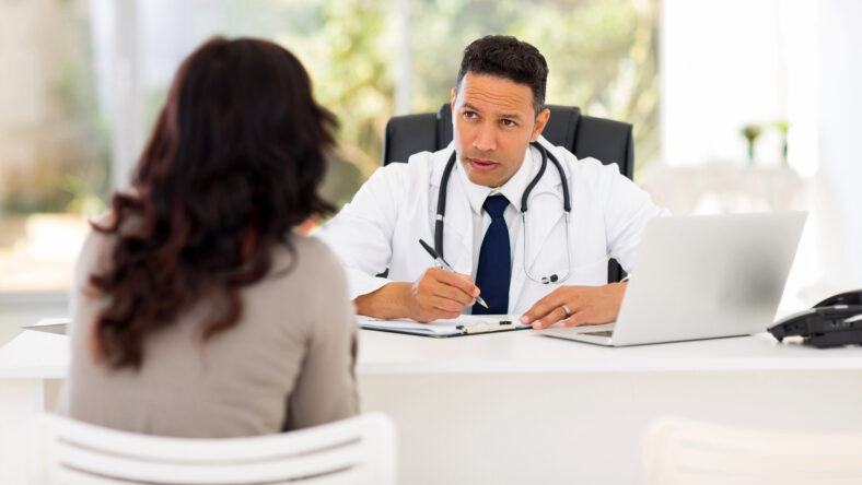 professional medical doctor consulting patient in office