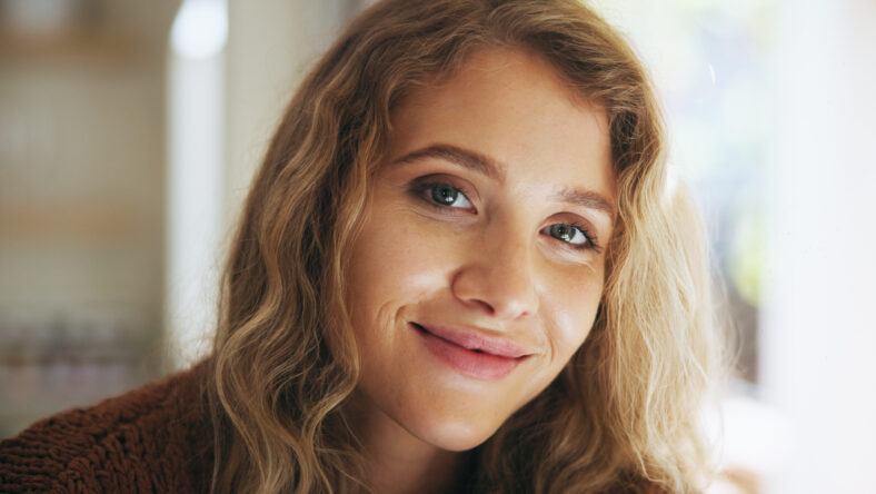 Happy woman, portrait and morning with self confidence or natural beauty in satisfaction at home. Face of young female person or freelancer with smile for positive attitude, style or future at house.