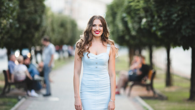 woman in a dress standing in a park