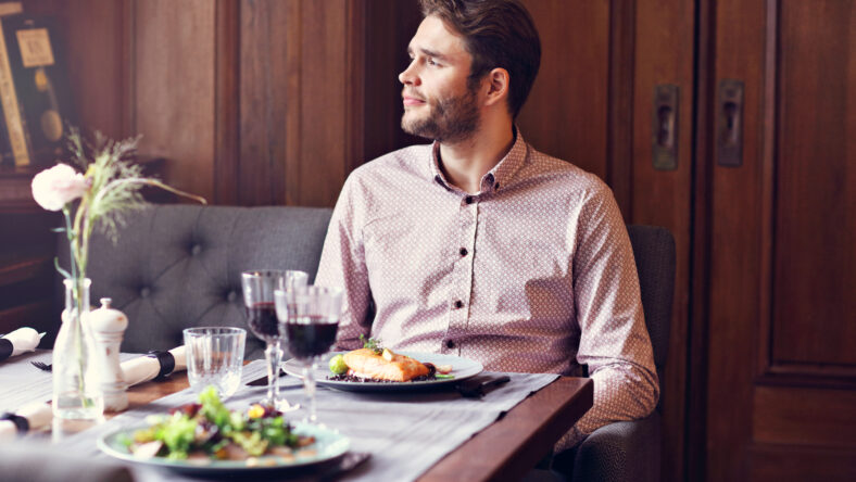 Picture showing handsome man waiting at table in restaurant