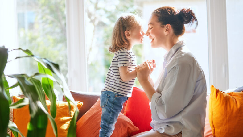 Happy mother's day! Mom and her daughter child girl are playing, smiling and hugging. Family holiday and togetherness.